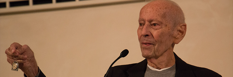 Curt Lowens holding up a pocket watch