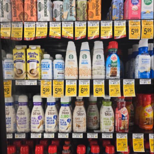 a variety of creamers on a store shelf