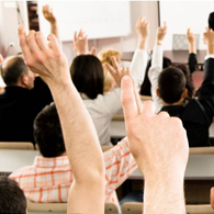 students raising their  hands for a question