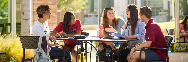 Chapman Student sitting together outside