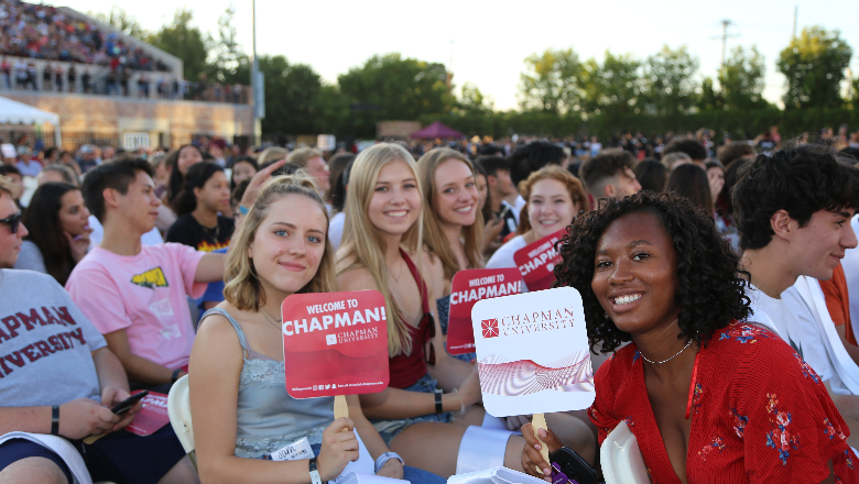 students smile as they wait for Convocation to begin