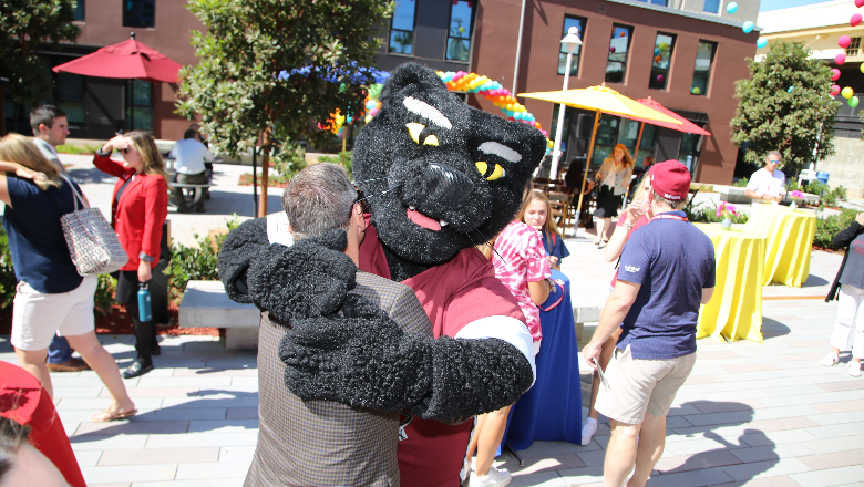 Pete the Panther hugs a friend of Chapman