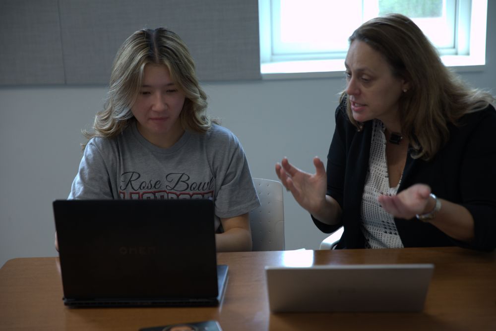 Dr. Karen Snedker discussing research with a summer 2026 participant.