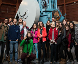 Group photo in front of a sculpture