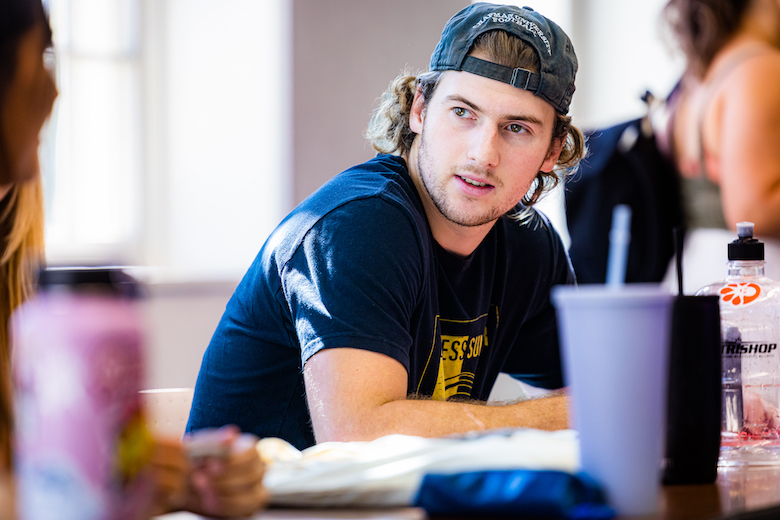 Wilkinson College student listening intently to classmate