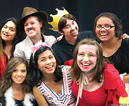 Group of students smiling in costumes.
